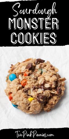 an oatmeal cookie with m & m cookies on top and the words sourdough monster cookies above it