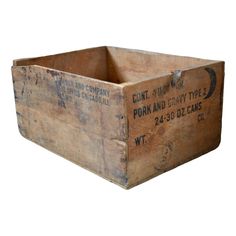 an old wooden box with writing on the front and bottom, sitting upright against a white background