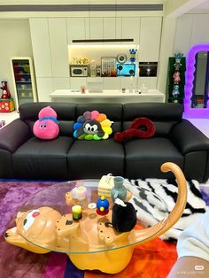 a living room filled with lots of furniture and decor on top of a purple rug