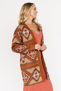 Baltic Born exclusive style Spice with rust, burgundy, and blue Fun patterns throughout Classy knit material Long sleeves Open front cardigan style Longer length 100% Acrylic Casey is 5'8, cup size 32B, size 2 and wearing size S Trina is 5'6, cup size 32D, size 2 and is wearing size S Bohemian Jacquard Knit Sweater For Fall, Fall Jacquard Knit Cardigan For Layering, Bohemian Brown Sweater Coat For Fall, Casual Jacquard Knit Sweater Coat For Fall, Brown Open Front Sweater Coat For Layering, Brown Jacquard Knit Outerwear For Fall, Cozy Jacquard Knit Cardigan For Fall, Bohemian Jacquard Knit Outerwear For Fall, Brown Open Front Sweater For Layering