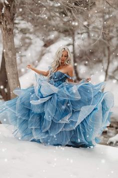 a woman wearing a blue dress in the snow