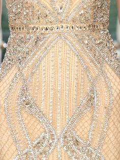 the back of a woman's dress with beading and sequins on it