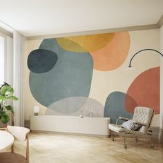 a living room with a couch, chair and large painting on the wall behind it