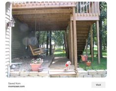 a dog is sitting on the porch in front of a house