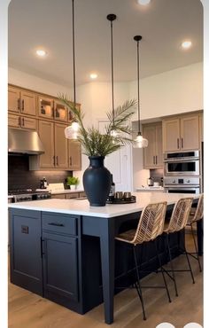 a kitchen island with chairs and a vase on it