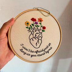 a hand embroidered heart with flowers and the words you're always doing what you stand by