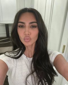 a woman making a funny face while taking a selfie