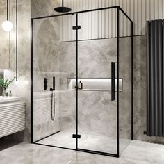 a bathroom with a walk in shower next to a white sink and radiator