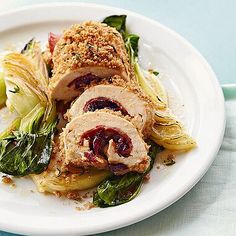 a white plate topped with meat and veggies on top of a blue table cloth