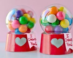 three snow globes filled with candy on top of a table