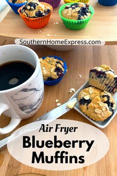 blueberry muffins on a plate next to a cup of coffee