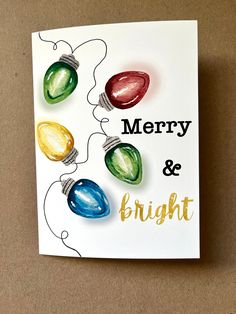 a card with christmas lights on it and merry and bright written on the front side