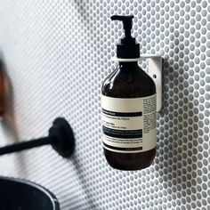 a hand soap dispenser hanging on the wall