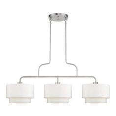 three light chandelier with white shades on the bottom and two lamps above it