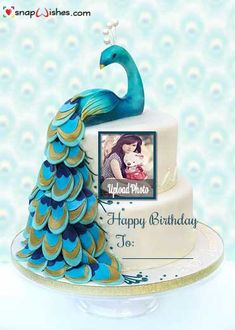 a birthday cake with a peacock on top and an image of a woman holding a baby