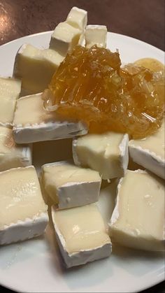 pieces of cheese and honey on a white plate