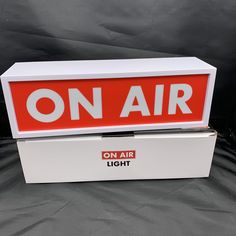 an on air light box sitting on top of a black sheet