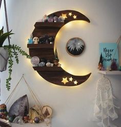 the moon and stars are lit up on the wall above the shelves in this room