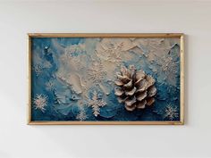 a painting hanging on the wall with snowflakes and pinecones in it