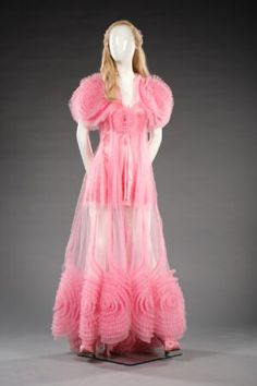 a mannequin wearing a pink dress with ruffles