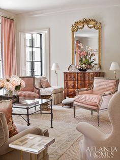 a living room filled with furniture and a mirror