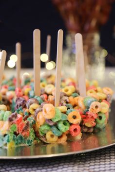 there is a cake made to look like cereals and candy bars with toothpicks sticking out of it