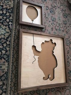 the shadow of a bear and balloon is hanging on the wall