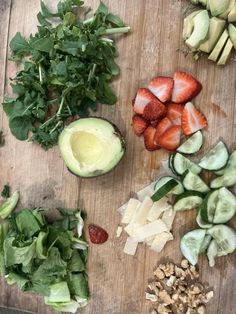 chopped up vegetables on a cutting board with avocado, strawberries and nuts