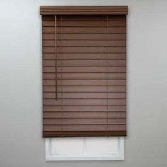 a window with brown blinds in the corner