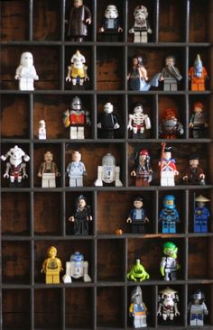 a shelf filled with lego star wars minifigurs on top of wooden shelves