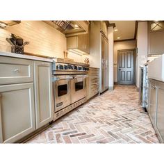 a kitchen with an oven, sink and refrigerator