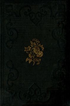 a black book with gold flowers on the front and back cover, in an ornate pattern