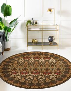 a living room area with a rug and potted plant on the side table in front of it