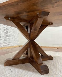 a wooden table sitting on top of a white rug