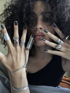 a woman with many rings on her fingers