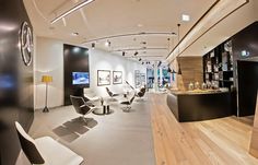 the interior of a hair salon with chairs and tables