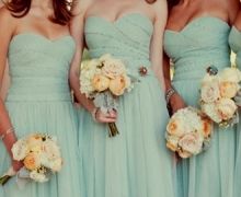 four bridesmaids in mint green dresses holding bouquets