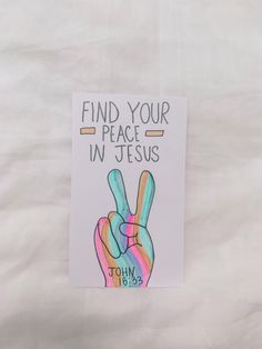 a card with the words find your peace in jesus written on it and an image of a hand holding a peace sign