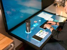 a man sitting at a table using a computer