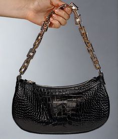 Editor's Notes: This is the must have accessory of the season for those memorable dinner and dancing evenings out on the town. It holds just the right amount of personal items without taking up much space. This handbag is made of croc printed leather with zip top opening and fashionable gold chain handle. Includes a leather strap too. Printed Italian locally sourced leather and hardware Zip top closure One zip interior pocket Two sewn in interior slip pockets Adjustable leather strap Length 11.5 Chic Evening Shoulder Bag With Crocodile Pattern, Elegant Baguette Bag With Zipper For Party, Elegant Party Baguette Bag With Zipper Closure, Luxury Crocodile Pattern Party Shoulder Bag, Croc Print, Top Handbags, Printed Leather, Black Handbags, Zip Top