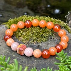 Banded Agate, Sunstone, Carnelian, Orange Calcite and Orange Aventurine handmade gemstone bracelet for good luck, protection and happiness.  Centered by a unique 10mm square banded agate and surrounded by 10mm chunky Boho crystal beads, this bracelet is like a personal force field, protecting from negative energies.  Activating the lower chakras, it grounds in nature's wisdom, freeing courage and creativity and opening the door to abundance and success, with good luck as an added bonus. Name:  Y Spiritual Carnelian Bracelet With Natural Stones, Spiritual Carnelian Gemstone Bracelet, Handmade Orange Agate Bracelets, Handmade Orange Agate Bracelet, Healing Carnelian Beaded Bracelets With Natural Stones, Orange Agate Gemstone Bracelets, Carnelian Beaded Bracelets With Natural Stones For Meditation, Adjustable Carnelian Gemstone Beaded Bracelet, Carnelian Beaded Bracelets With Natural Stones As Gift