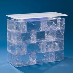 an ice chest with several cubes in it on a blue background, the top section is empty