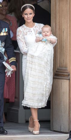 the duke and princess of cambridge with their baby son prince george, who is dressed in white