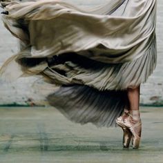 a woman in a dress and high heels is dancing