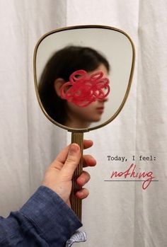 a person holding up a mirror with an octopus on it's side and the words today, i feel nothing