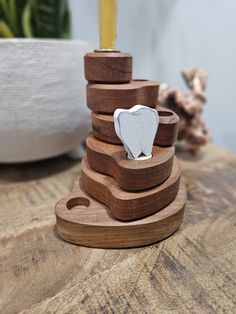 a wooden stand with a silver heart on it