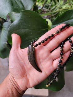 Obsidian Necklace, Golden Sheen Obsidian Necklace, Long Necklace, Beaded Necklace, Hand Knotted, Unisex, Boho Necklace, Wolf Necklace, Gold Necklace Beautiful 6mm golden sheen Obsidian beads hand knotted for security. The small gold beads are 14k gold and the clasp, extender are stainless steel. The pendant is also golden sheen Obsidian and is 59mm long. The shape is like an ivory tusk, slight curved. Obsidian Necklace With 8mm Beads As Gift, Obsidian Pendant Amulet Necklace, Obsidian Amulet Pendant Necklace, Black Hand-strung Amulet Necklace, Black Amulet Style Necklaces With Polished Beads, Black Amulet Necklaces With Polished Beads, Black Amulet Necklace With Polished Beads, Obsidian Necklace With Gemstone Beads As Gift, Obsidian Gemstone Beads Necklace For Gift