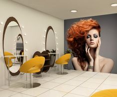 a woman with bright red hair is sitting in front of a mirror and yellow chairs