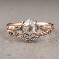 an engagement ring with a large white diamond in the center and two smaller diamonds on each side