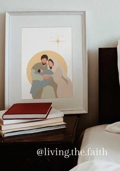 a framed image of a man holding a woman in his arms on top of a bed next to a stack of books